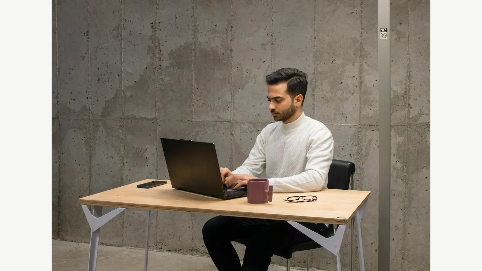 A person working at a desk with a laptop.