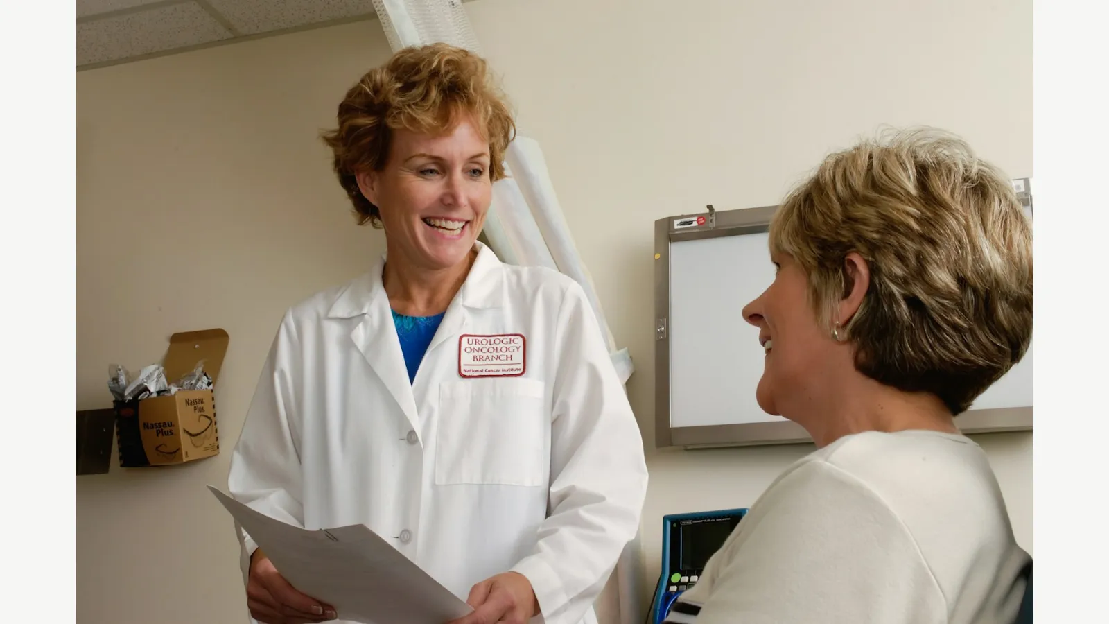 A doctor discussing care with a patient in a clinic.