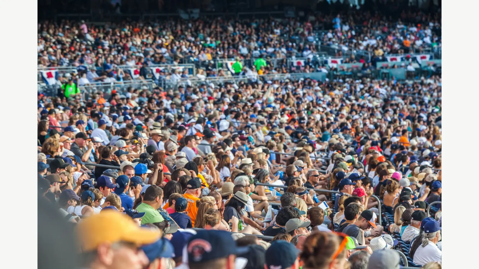 Spectators seated around a baseball stadium.