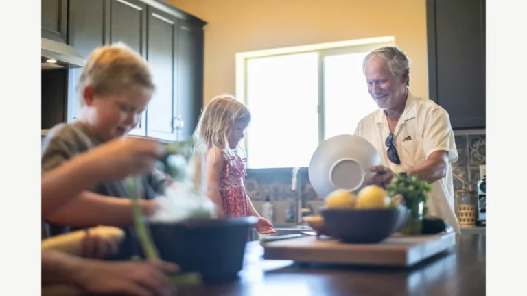 Family members preparing food together in a kitchen.